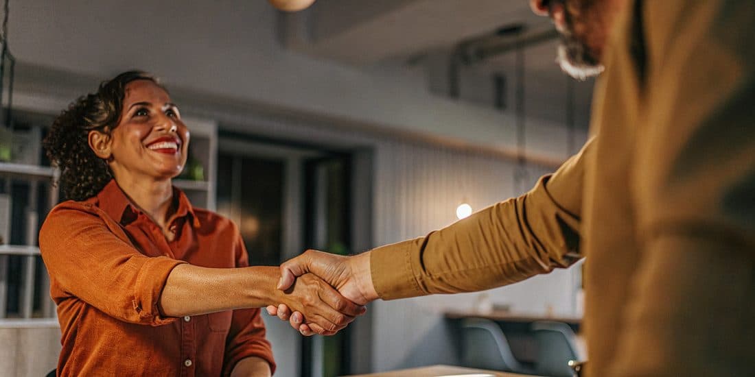 A Lyft Capital advisor shaking hands with a relieved business owner